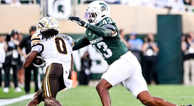 Michigan State's Malik Spencer, right, tackles Western Michigan's Tailique Williams during the first quarter on Friday, Aug. 29, 2025, in East Lansing. (© Nick King/Lansing State Journal / USA TODAY NETWORK via Imagn