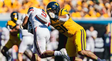 West Virginia defensive linman Devin Grant makes the tackle against Robert Morris