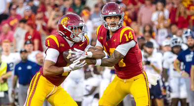 USC quarterback Jayden Maiava hands off to running back Eli Sanders