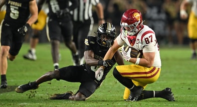 Purdue Boilermakers defensive back Tony Grimes (0) tackles USC Trojans tight end Lake McRee (87) during the second half at Ross-Ade Stadium