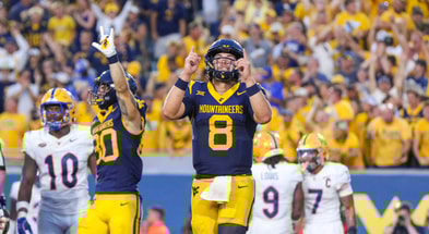 West Virginia quarterback Nicco Marchiol celebrates the touchdown against Pitt