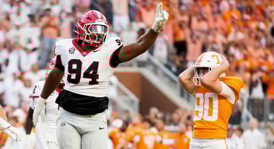 Brianna Paciorka/News Sentinel / USA TODAY NETWORK via Imagn Images | Tennessee place kicker Max Gilbert (90) holds his helmet in disbelief as Georgia defensive lineman Xzavier McLeod (94) celebrates Gilbert's missed field goal in the final seconds of a college football game between Tennessee and Georgia at Neyland Stadium in Knoxville, Tenn., on Sept. 13, 2025.