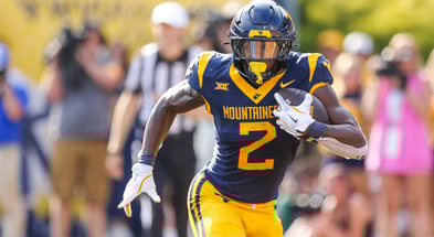 West Virginia running back Tye Edwars carries the ball against Pitt