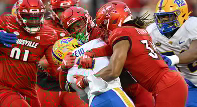 Nov 23, 2024; Louisville, Kentucky, USA; Louisville Cardinals linebacker Stanquan Clark (6) and linebacker TJ Quinn (34) tackle Pittsburgh Panthers running back Desmond Reid (0) during the first half at L&N Federal Credit Union Stadium. Mandatory Credit: Jamie Rhodes-Imagn Images