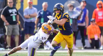 West Virginia Mountaineers running back Clay Ash breaks the tackle against Pitt