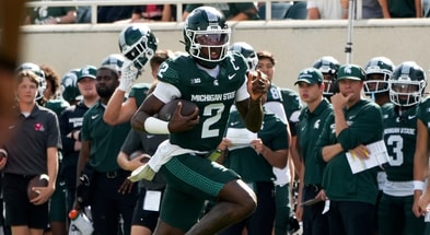 Michigan State quarterback Aidan Chiles (2) runs for a first down against Youngstown State in the first quarter at Spartan Stadium