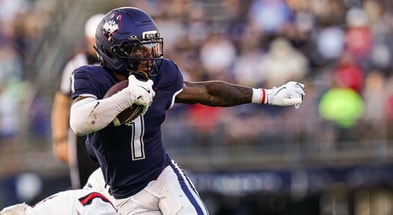 UConn Football RB Cam Edwards (1) runs away from a Ball State defender
