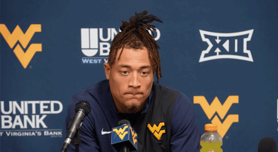 West Virginia wide receiver Rodney Gallagher talks with the media