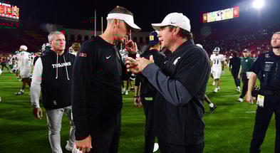 USC Trojans head coach Lincoln Riley meets with Michigan State Spartans head coach Jonathan Smith following the game at the Los Angeles Memorial Coliseum