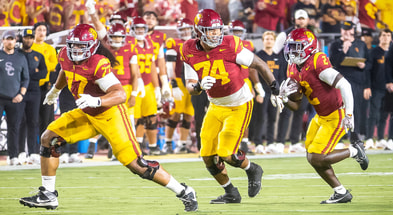 USC offensive linemen Alani Noa and Justin Tauanuu block for running back Waymond Jordan