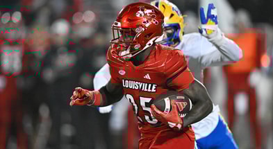 Nov 23, 2024; Louisville, Kentucky, USA; Louisville Cardinals running back Isaac Brown (25) runs against the Pittsburgh Panthers during the second half at L&N Federal Credit Union Stadium. Louisville defeated Pittsburgh 37-9. Mandatory Credit: Jamie Rhodes-Imagn Images