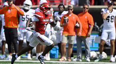 Sep 20, 2025; Louisville, Kentucky, USA; Louisville Cardinals wide receiver Caullin Lacy (5) runs the ball for a touchdown against the Bowling Green Falcons during the first half at L&N Federal Credit Union Stadium. Mandatory Credit: Jamie Rhodes-Imagn Images