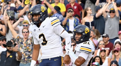 Cal quarterback Jaron-Keawe Sagapolutele and receiver Jacob De Jesus