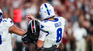 Sep 27, 2025; Columbia, South Carolina, USA; South Carolina Gamecocks linebacker Desmond Umeozulu (9) hits Kentucky Wildcats quarterback Cutter Boley (8) as he passes which causes an interception in the second quarter at Williams-Brice Stadium. Mandatory Credit: Jeff Blake-Imagn Images