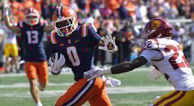 Illinois Fighting Illini wide receiver Justin Bowick (0) runs past USC Trojans cornerback Braylon Conley (22) and scores on a 25 yard reception for a touchdown during the second half at Memorial Stadium