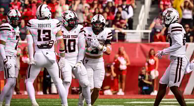 Texas Tech LB Ben Roberts punches out a ball as LB John Curry recovers it