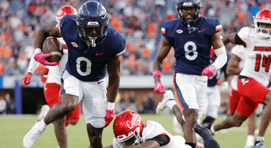 Oct 12, 2024; Charlottesville, Virginia, USA; Virginia Cavaliers running back Xavier Brown (0) carries the ball to score a touchdown against the Louisville Cardinals during the second half at Scott Stadium. Mandatory Credit: Amber Searls-Imagn Images