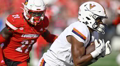 Oct 4, 2025; Louisville, Kentucky, USA; Virginia Cavaliers wide receiver Cam Ross (6) catches a pass against Louisville Cardinals defensive back D'Angelo Hutchinson (21) during the second quarter at L&N Federal Credit Union Stadium. Mandatory Credit: Jamie Rhodes-Imagn Images