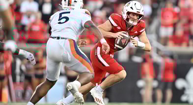 Oct 4, 2025; Louisville, Kentucky, USA; Louisville Cardinals quarterback Miller Moss (7) scrambles under the pressure of Virginia Cavaliers linebacker Kam Robinson (5) during the second half at L&N Federal Credit Union Stadium. Virginia defeated Louisville 30-27. Mandatory Credit: Jamie Rhodes-Imagn Images