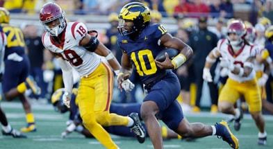 Michigan Wolverines quarterback Alex Orji (10) rushes against the USC Trojans at Michigan Stadium