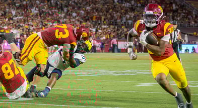 USC lineman Tobias Raymond blocks a Michigan defender as running back King Miller runs for a touchdown