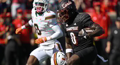 Oct 19, 2024; Louisville, Kentucky, USA; Louisville Cardinals wide receiver Chris Bell (0) runs the ball against the Miami Hurricanes during the first half at L&N Federal Credit Union Stadium. Mandatory Credit: Jamie Rhodes-Imagn Images