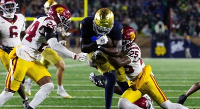 Notre Dame Fighting Irish running back Jeremiyah Love (4) runs the ball while USC Trojans cornerback Marcelles Williams (25) defends in the second half at Notre Dame Stadium