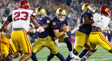 Notre Dame quarterback CJ Carr, center, runs with the ball in the second half of a NCAA football game against USC at Notre Dame Stadium on Saturday, Oct. 18, 2025, in South Bend