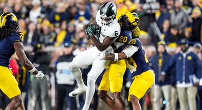 Michigan State wide receiver Nick Marsh (6) makes a catch against Michigan defensive backs Jyaire Hill (20) and Quinten Johnson (28) during the first half at Michigan Stadium in Ann Arbor. - Junfu Han, USA TODAY Sports