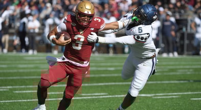 Oct 18, 2025; Chestnut Hill, Massachusetts, USA; Boston College Eagles quarterback Grayson James (3) stiff arms UConn Huskies linebacker Aaron Key (5) during the first half at Alumni Stadium. Mandatory Credit: Bob DeChiara-Imagn Images