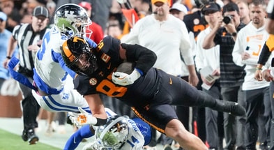 Tennessee tight end Miles Kitselman (87) is tackled by Kentucky defensive back Ty Bryant (14) and Kentucky defensive back Jordan Lovett (25) during an NCAA college football game between Tennessee and Kentucky on Saturday, Nov. 2, 2024, in Knoxville, Tenn. (© Caitie McMekin/News Sentinel / USA TODAY NETWORK via Imagn Images)
