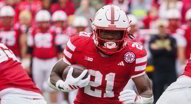 Nebraska football running back Emmett Johnson (21) runs the ball against the Northwestern Wildcats during the first quarter at Memorial Stadium.