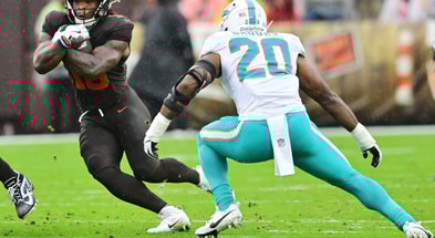 Oct 19, 2025; Cleveland, Ohio, USA; Cleveland Browns running back Quinshon Judkins (10) runs with the ball against Miami Dolphins linebacker Jordyn Brooks (20) during the first quarter at Huntington Bank Field.