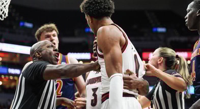 A referee has to separate Bucknell Bison forward Amon Dörries (22) and Louisville Cardinals forward Khani Rooths (9) during an exhibition game at the KFC Yum! Center in Louisville, Kentucky Tuesday October 28, 2028.