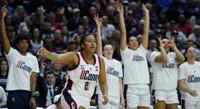 UConn's bench celebrates a three-pointer