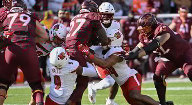 Nov 1, 2025; Blacksburg, Virginia, USA; Louisville Cardinals defensive back Antonio Watts (9) tackles Virginia Tech Hokies running back Marcellous Hawkins (27) during the first quarter at Lane Stadium. Mandatory Credit: Brian Bishop-Imagn Images