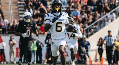 West Virginia defensive back Jordan Scruggs returns the pick-six against Houston