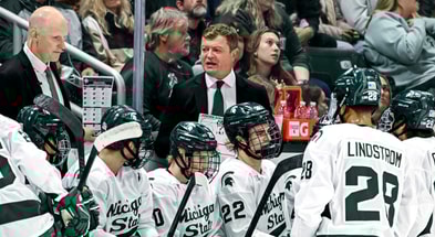 Michigan State's head coach Adam Nightingale, center, talks with the team during a break in the action in the first period of the game against New Hampshire on Thursday, Oct. 9, 2025. - Nick King, USA TODAY Sports