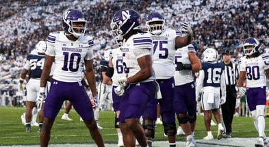 Northwestern Wildcats wide receiver Ricky Ahumaraeze (10) and offensive lineman Martes Lewis (75) celebrate with running back Caleb Komolafe (5) after scoring a touchdown during the fourth quarter against the Penn State Nittany Lions at Beaver Stadium