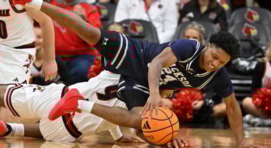 Nov 6, 2025; Louisville, Kentucky, USA; Jackson State Tigers guard Daeshun Ruffin (24) scrambles for the ball with Louisville Cardinals forward Khani Rooths (9) during the second half at KFC Yum! Center. Louisville defeated Jackson State 106-70. Mandatory Credit: Jamie Rhodes-Imagn Images