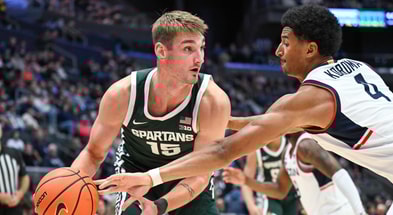 Connecticut Huskies forward Dwayne Koroma (4) knocks the ball away from Michigan State Spartans center Carson Cooper (15) during the second half at PeoplesBank Arena. - Mark Smith, USA TODAY Sports
