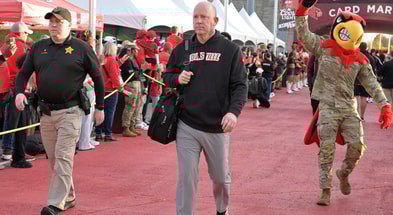 Nov 8, 2025; Louisville, Kentucky, USA; Louisville Cardinals head coach Jeff Brohm greets fans during the Card March before facing off against the California Golden Bears at L&N Federal Credit Union Stadium. Mandatory Credit: Jamie Rhodes-Imagn Images
