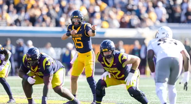 West Virginia Mountaineers quarterback Scotty Fox Jr. (15) changes the play at the line of scrimmage during the first quarter against the Colorado Buffaloes at Milan Puskar Stadium. Credit: Ben Queen-Imagn Images