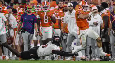 Nov 2, 2024; Clemson, South Carolina, USA; Clemson Tigers quarterback Cade Klubnik (2) runs against Louisville Cardinals linebacker Stanquan Clark (6) during the second quarter at Memorial Stadium. Mandatory Credit: Ken Ruinard-Imagn Images