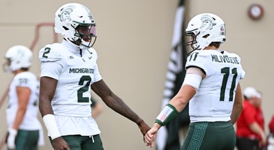 Michigan State Spartans quarterback Aidan Chiles (2) fist pumps Michigan State Spartans quarterback Alessio Milivojevic (11) prior to the game against the Indiana Hoosiers at Memorial Stadium. - Robert Goddin, USA TODAY Sports