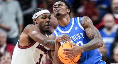 Louisville Cardinals guard Ryan Conwell (3) tussles with Kentucky Wildcats guard Otega Oweh (00) for control in the first half suring the UofL-UK annual rivalry game at the KFC Yum! Center in Louisville, Kentucky Nov. 11, 2025.
