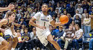 West Virginia guard Jasper Floyd drives against Lehigh
