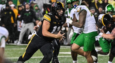 Iowa Hawkeyes quarterback Mark Gronowski (11) runs for a touchdown during the fourth quarter against the Oregon Ducks at Kinnick Stadium