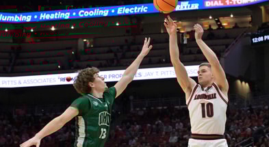 Nov 15, 2025; Louisville, Kentucky, USA; Louisville Cardinals guard Isaac McKneely (10) shoots against Ohio Bobcats guard Jackson Paveletzke (13) during the first half at KFC Yum! Center. Mandatory Credit: Jamie Rhodes-Imagn Images
