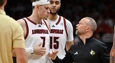 Nov 15, 2025; Louisville, Kentucky, USA; Louisville Cardinals head coach Pat Kelsey talks with forward Kasean Pryor (7) during the first half against the Ohio Bobcats at KFC Yum! Center. Mandatory Credit: Jamie Rhodes-Imagn Images